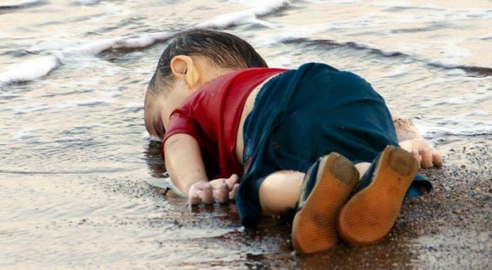 This photo is of Aylan Kurdi, a Syrian refugee child. His family attempted to cross from Bodrum, Turkey to Kos, Greece. He is one of 2,600 Syrian refugees who has died in their attempt to cross into Europe.